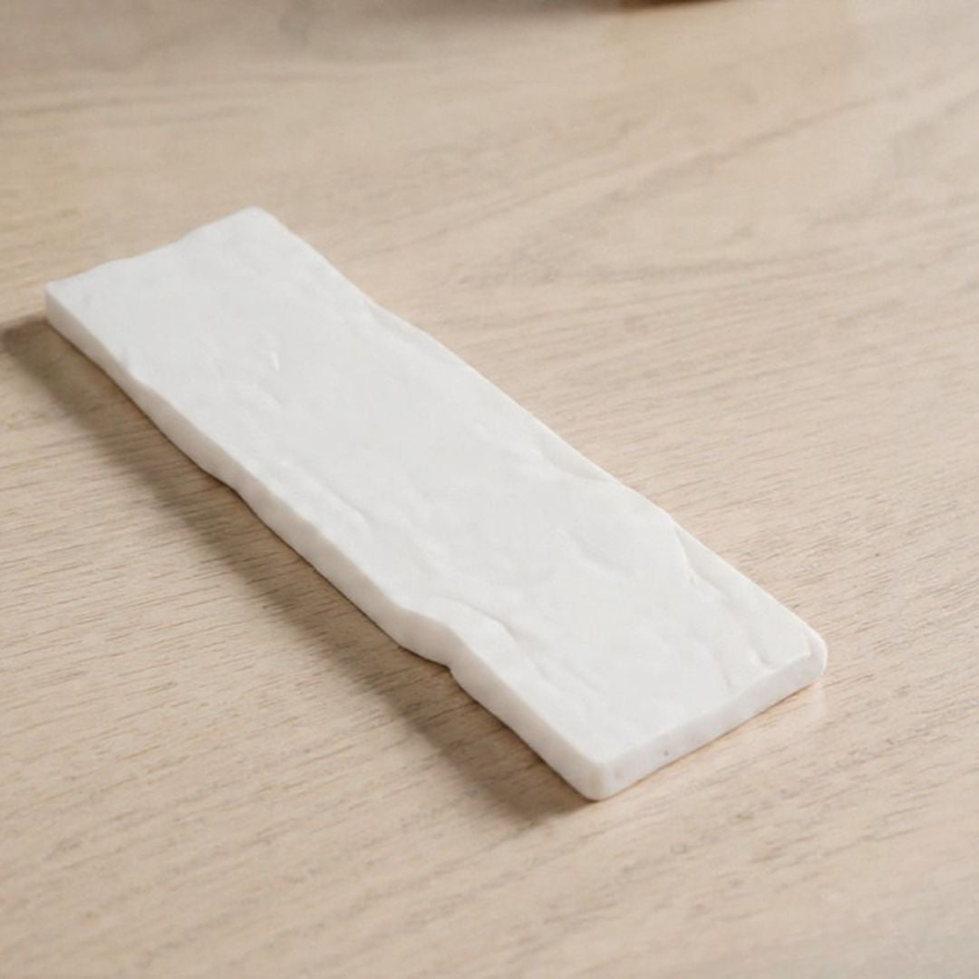 Tira de fibra blanca de repuesto para el quemador, sobre una superficie de madera clara